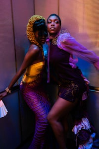 two women posing for a picture in an elevator